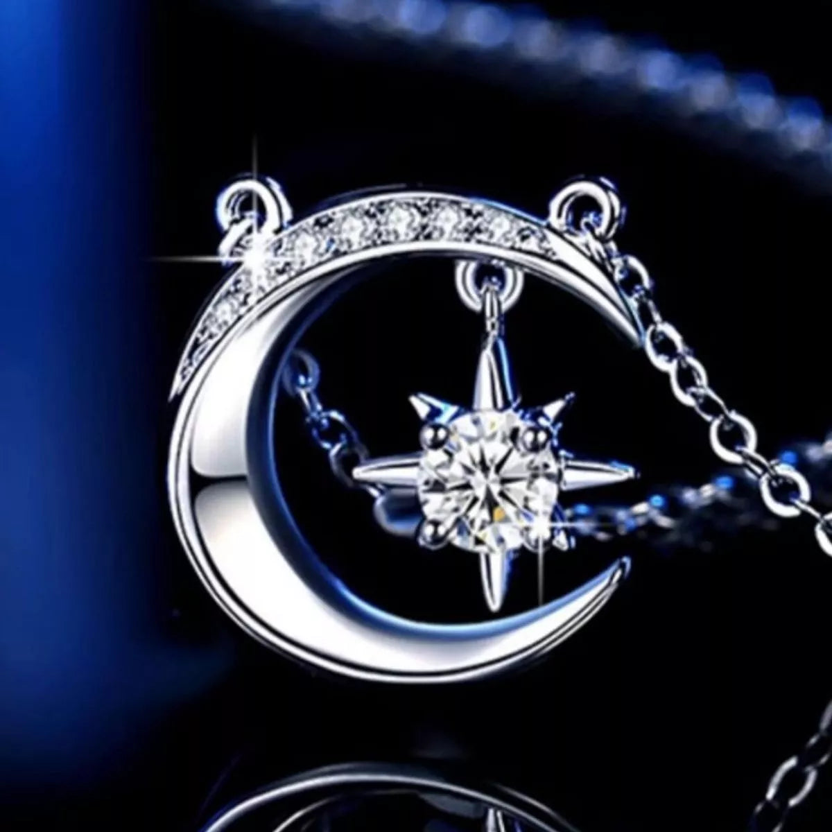 Sterling silver crescent moon necklace with a sparkling moissanite star pendant on a delicate silver chain.
