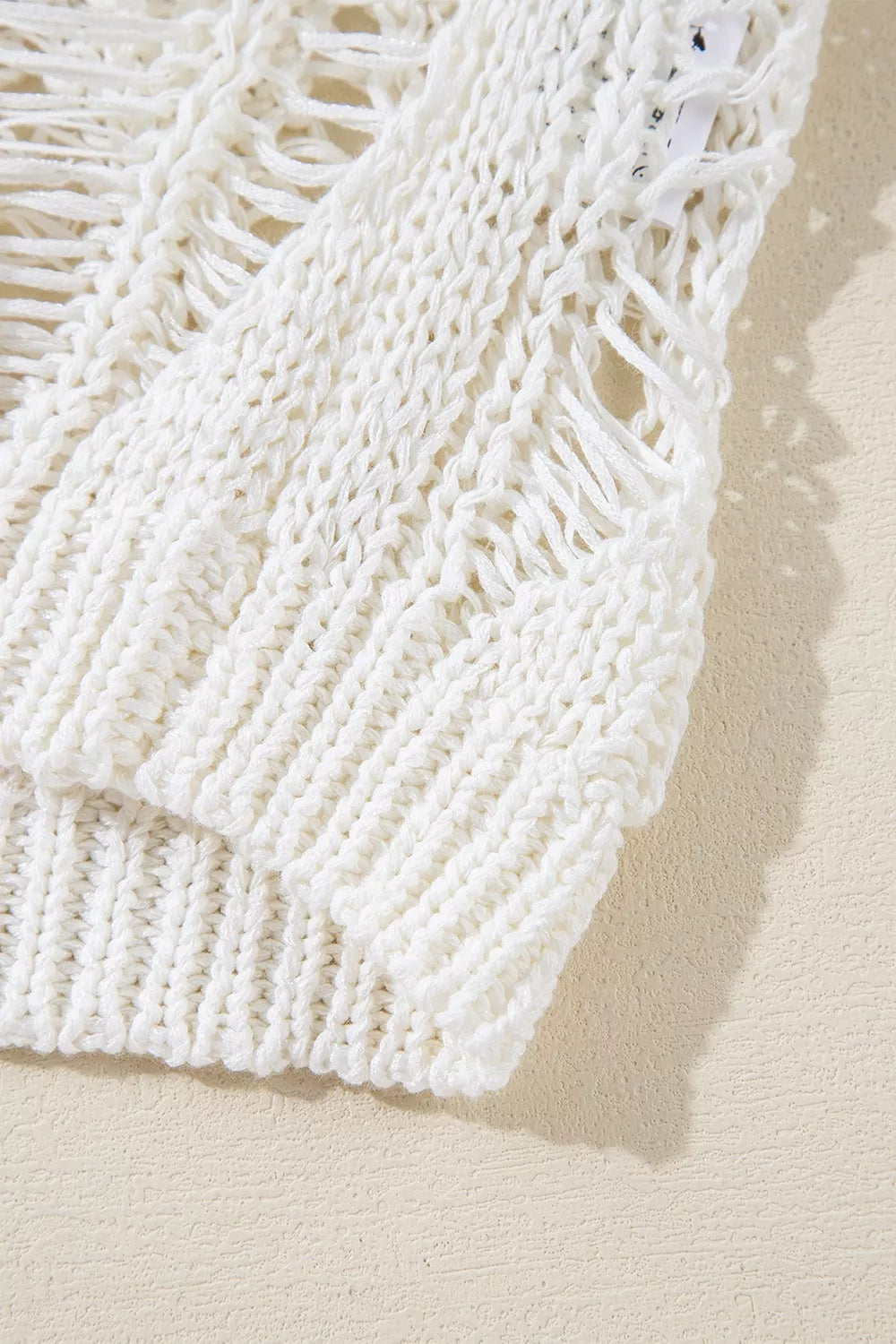 Ivory open knit boho sweater with long sleeves and intricate cutout pattern