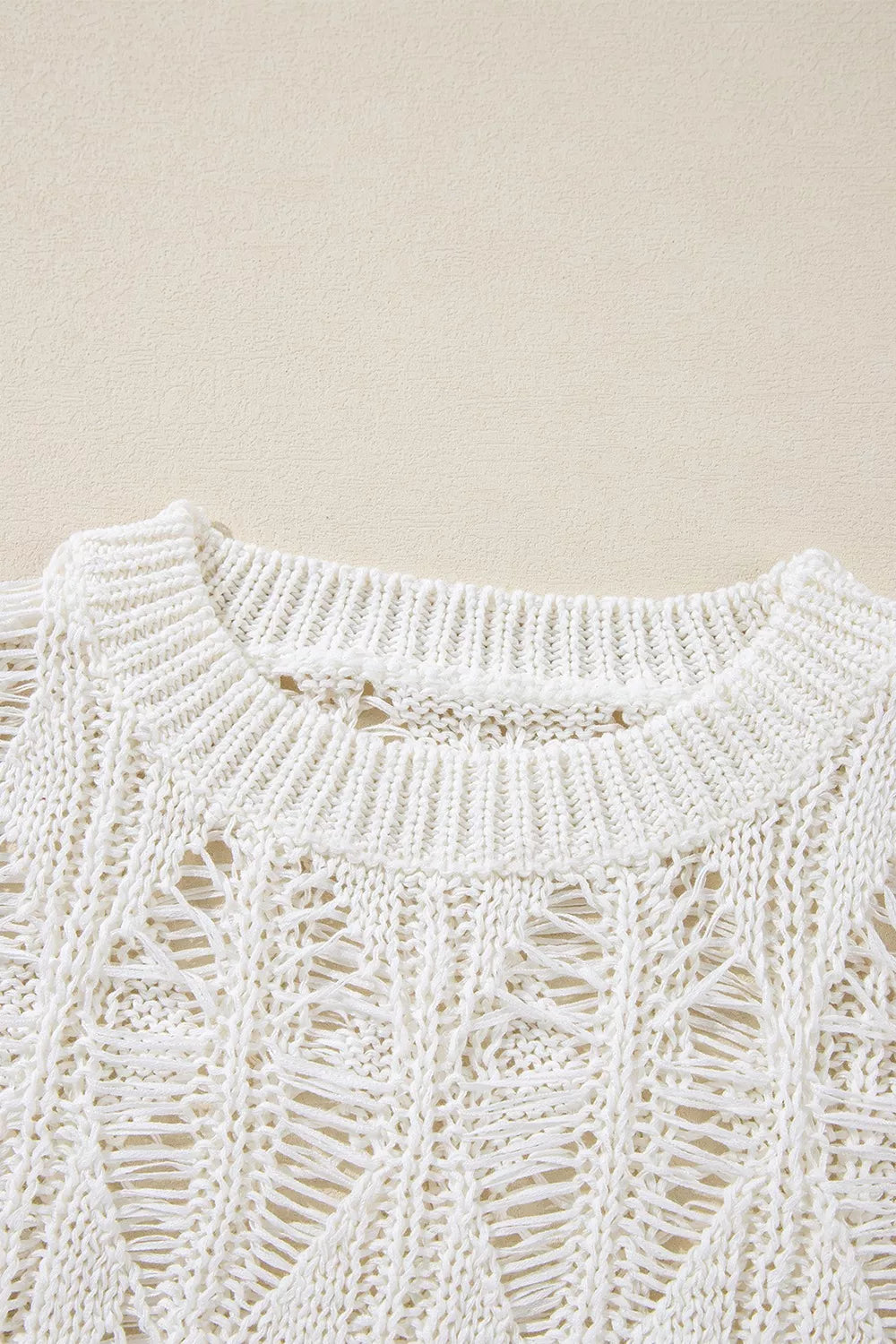 Ivory open knit boho sweater with long sleeves and intricate cutout pattern