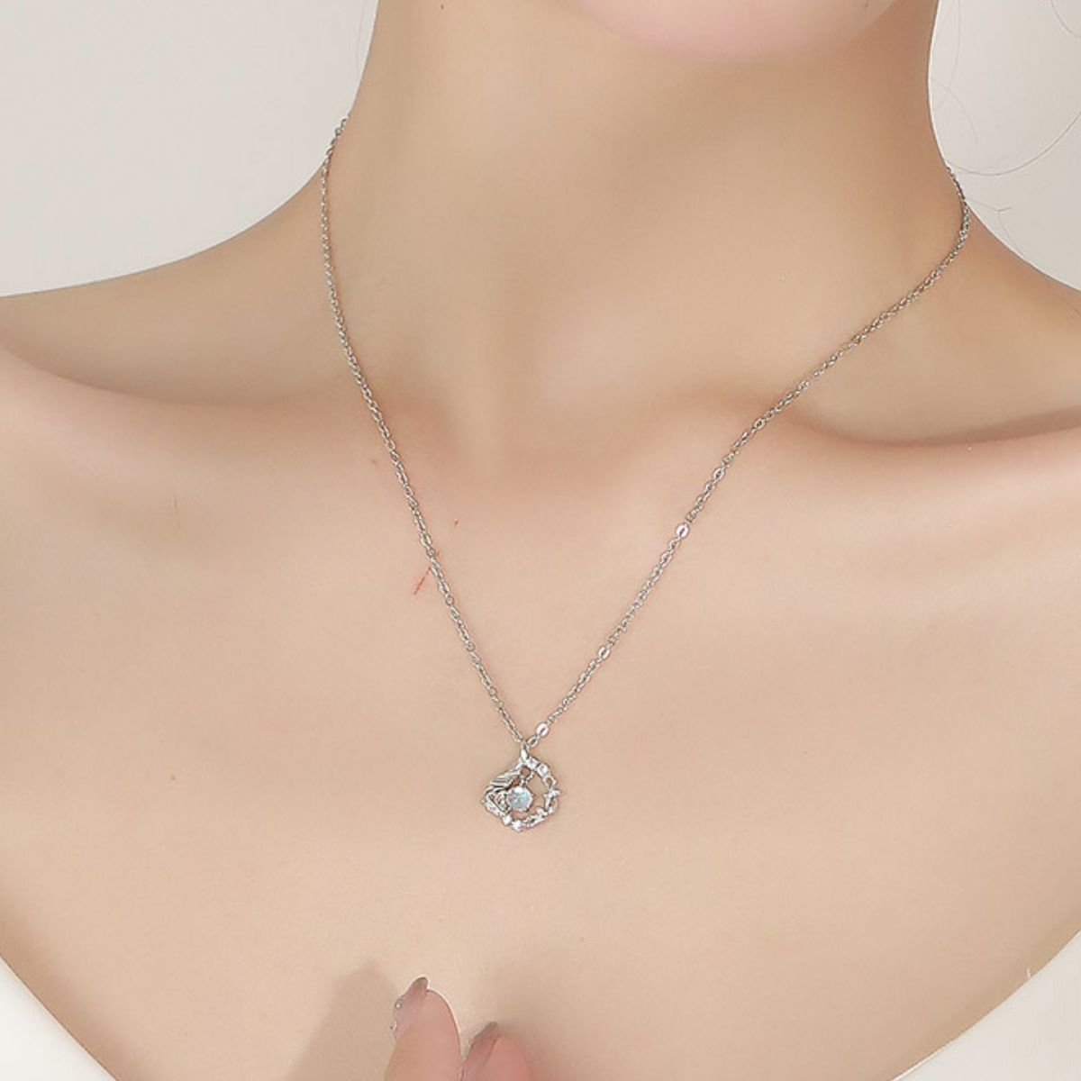 Sterling silver pendant necklace with opal center stone and feather detail