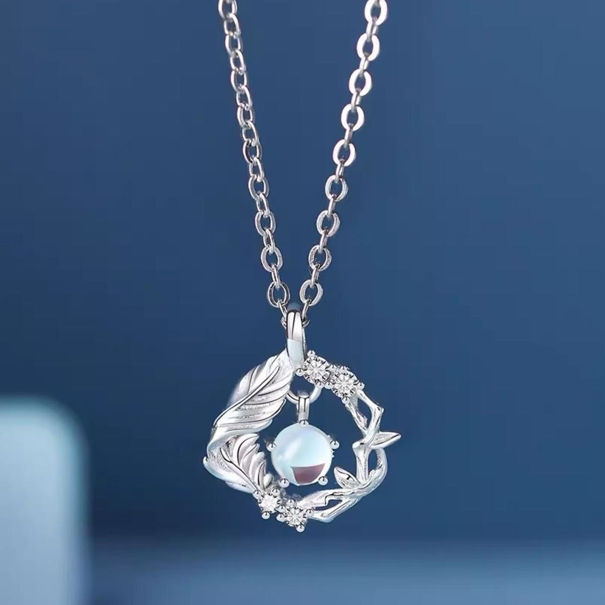 Sterling silver pendant necklace with opal center stone and feather detail