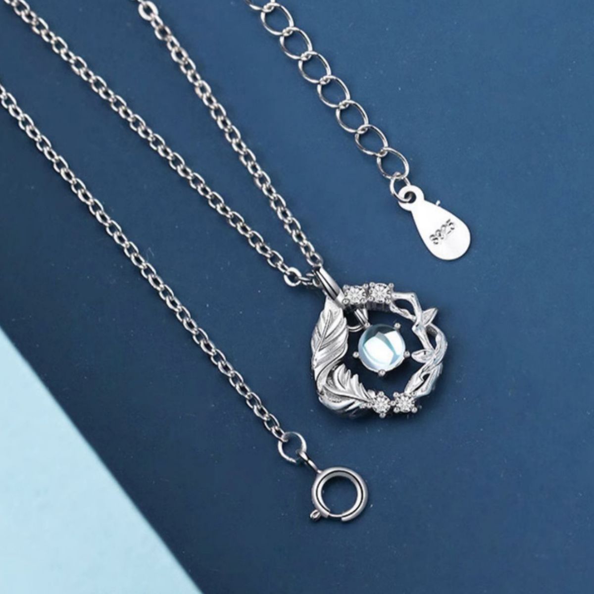 Sterling silver pendant necklace with opal center stone and feather detail