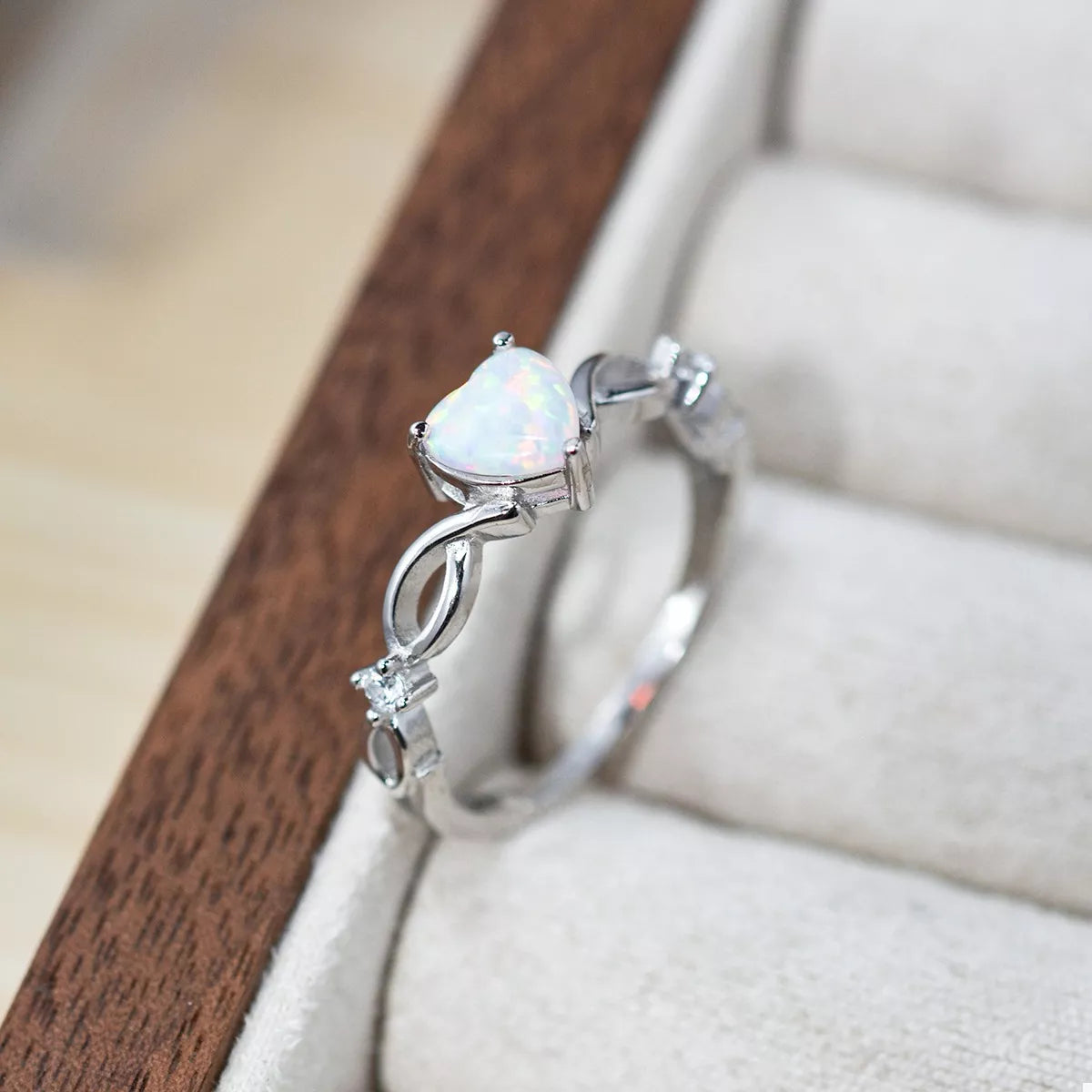 Heart-shaped opal ring with platinum-plated sterling silver infinity band and zircon accents