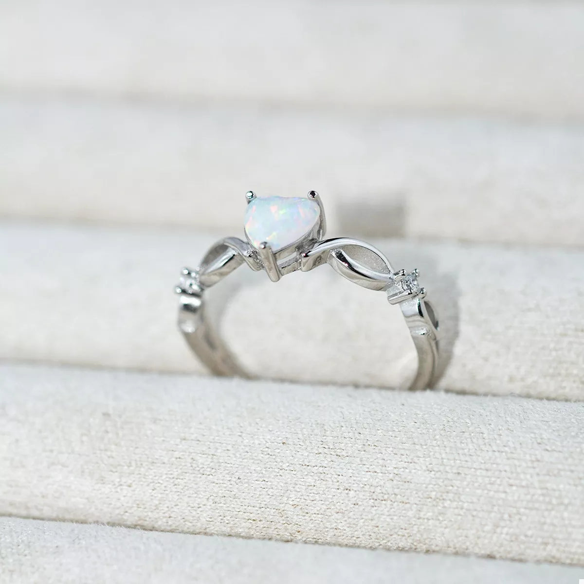 Heart-shaped opal ring with platinum-plated sterling silver infinity band and zircon accents