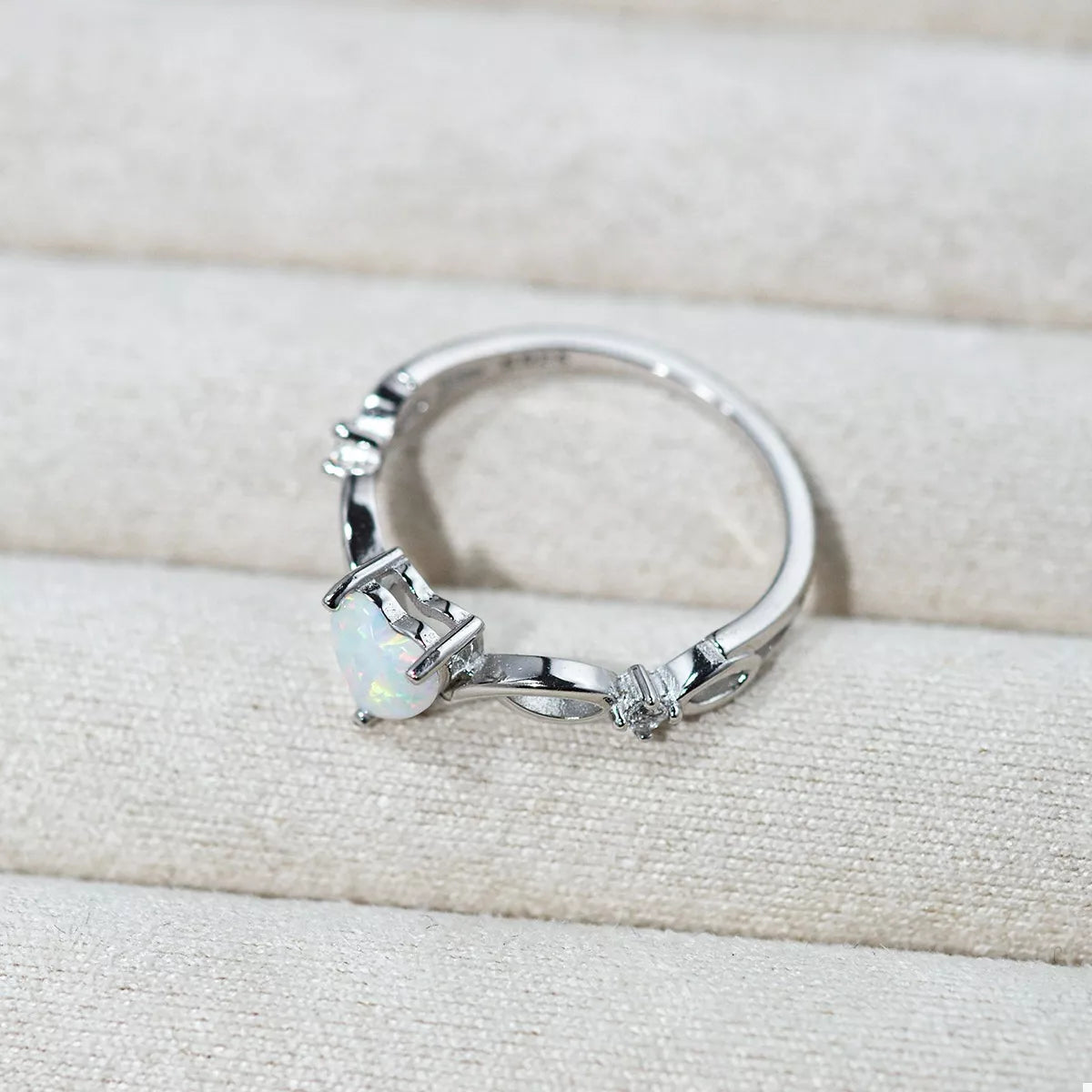 Heart-shaped opal ring with platinum-plated sterling silver infinity band and zircon accents
