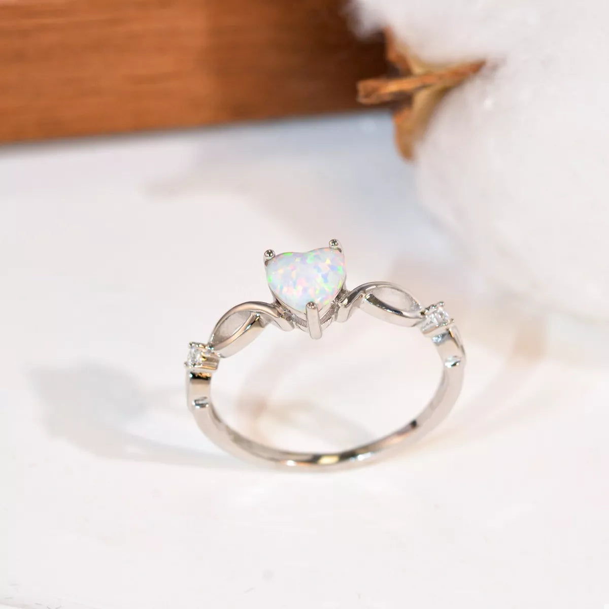 Heart-shaped opal ring with platinum-plated sterling silver infinity band and zircon accents