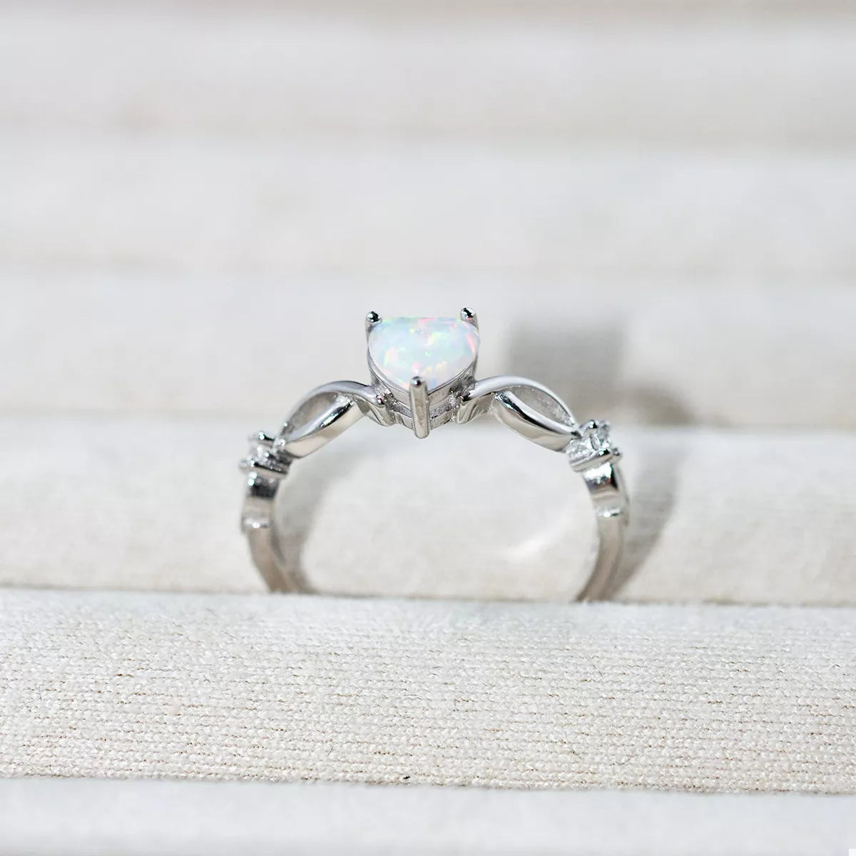 Heart-shaped opal ring with platinum-plated sterling silver infinity band and zircon accents