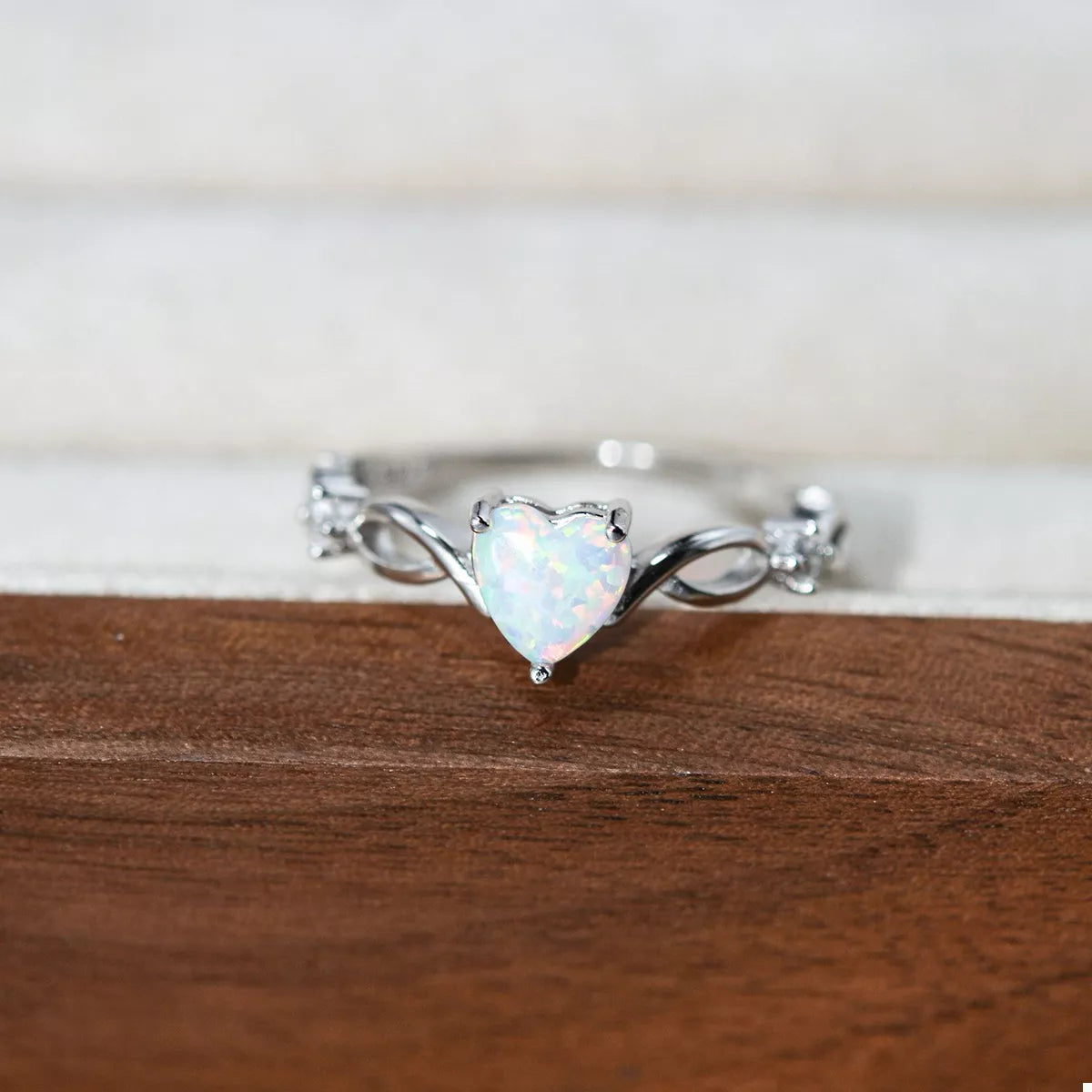 Heart-shaped opal ring with platinum-plated sterling silver infinity band and zircon accents
