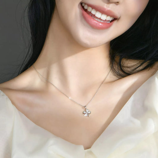 delicate sterling silver four leaf clover necklace with sparkling zircon pendant worn on minimalist chain