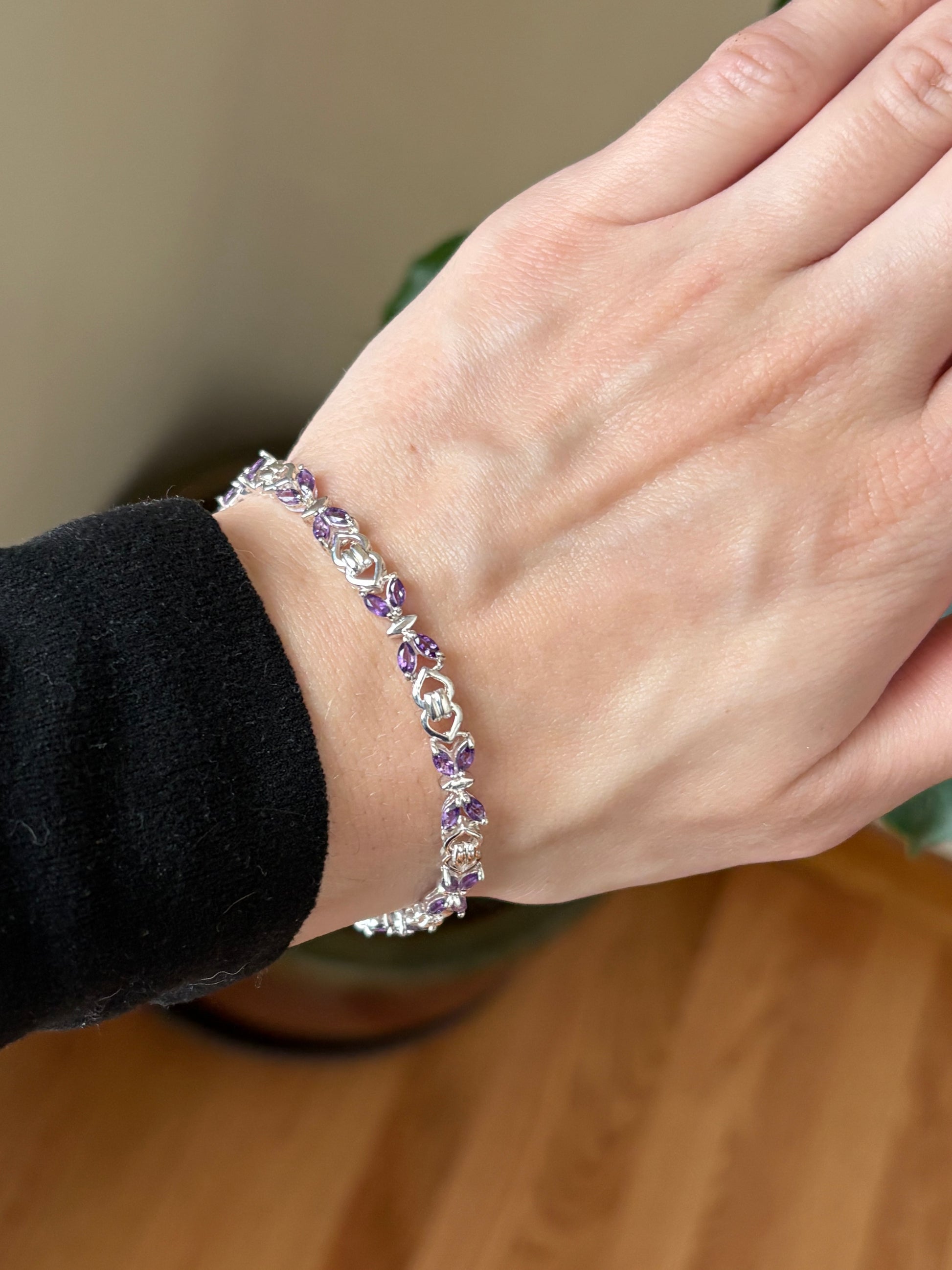 Sterling silver amethyst bracelet from the Enchanted Crystals Collection, featuring delicate purple stones in a lightweight design.
