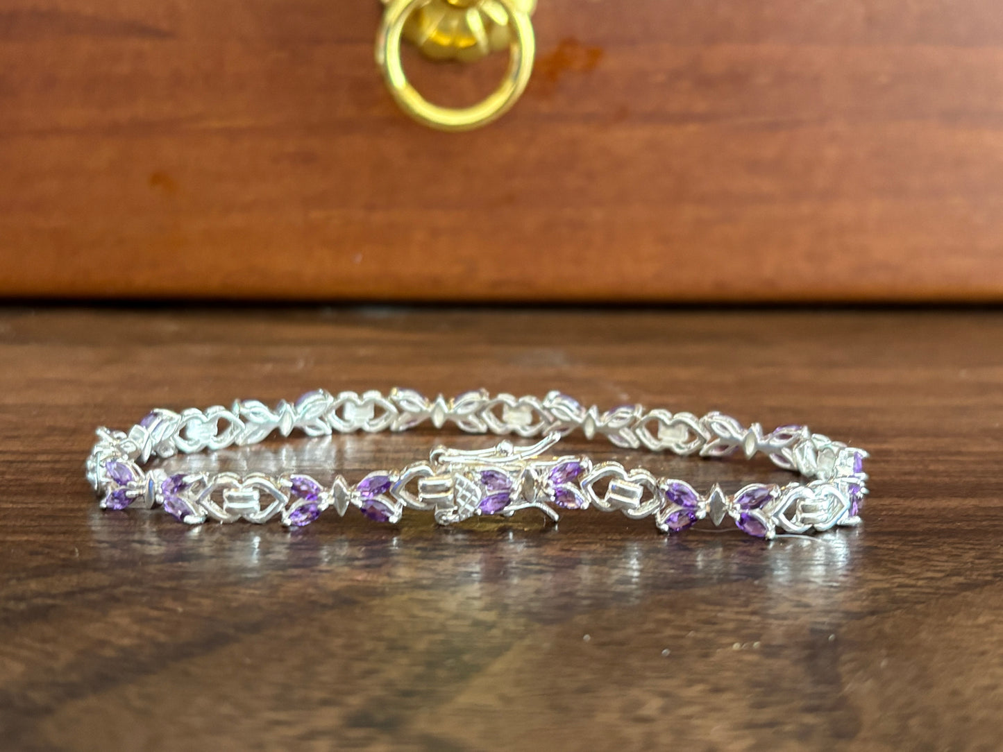 Sterling silver amethyst bracelet from the Enchanted Crystals Collection, featuring delicate purple stones in a lightweight design.