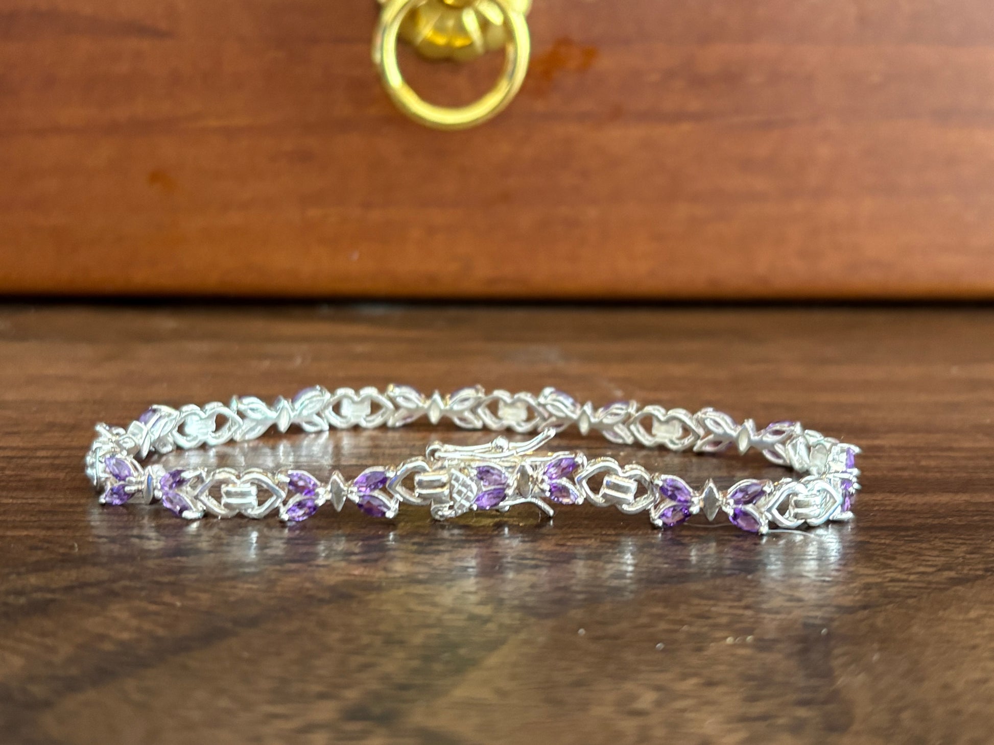 Sterling silver amethyst bracelet from the Enchanted Crystals Collection, featuring delicate purple stones in a lightweight design.