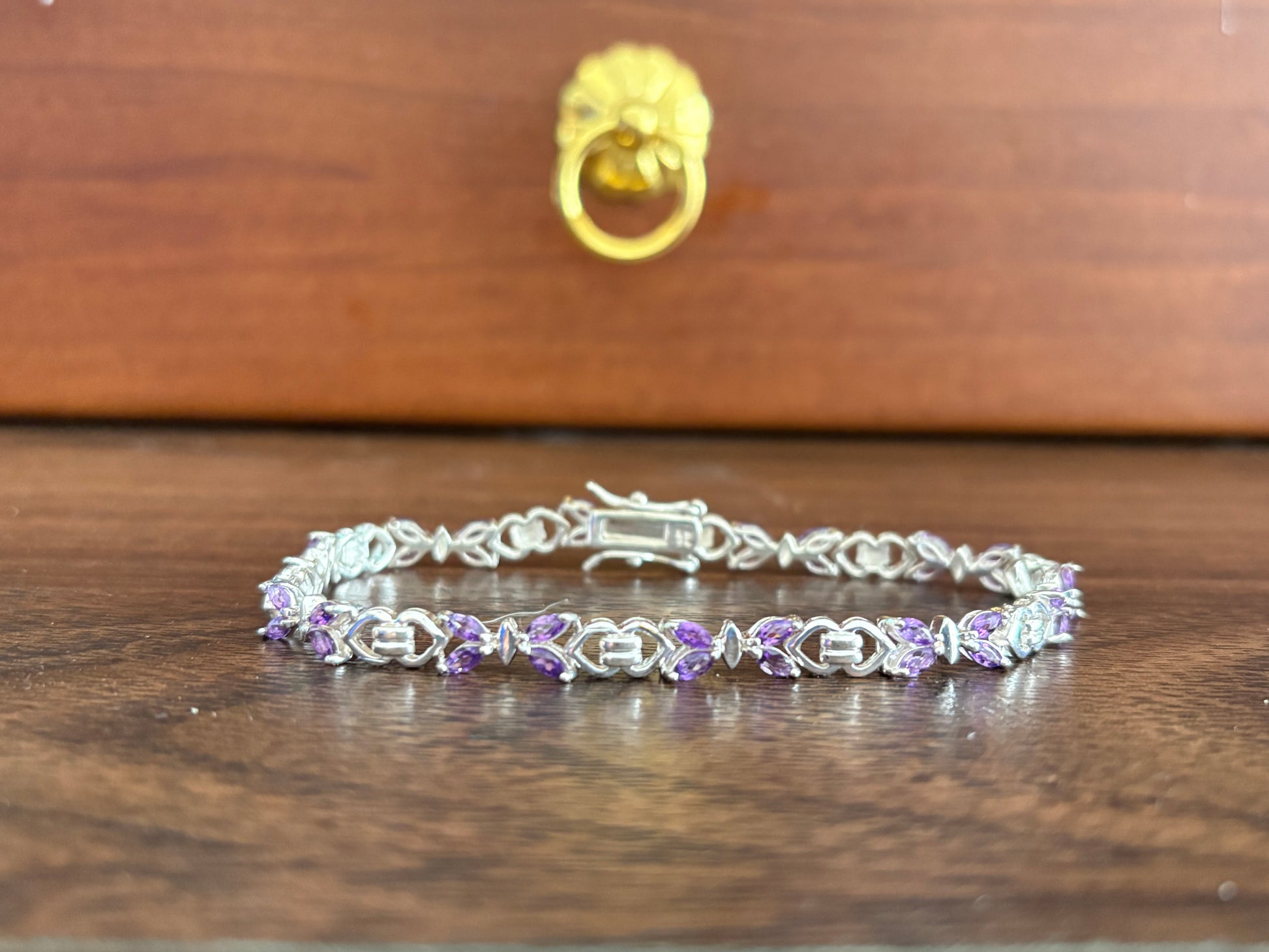 Sterling silver amethyst bracelet from the Enchanted Crystals Collection, featuring delicate purple stones in a lightweight design.