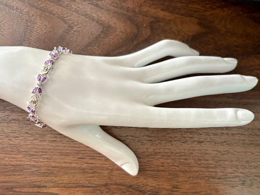 Sterling silver amethyst bracelet from the Enchanted Crystals Collection, featuring delicate purple stones in a lightweight design.