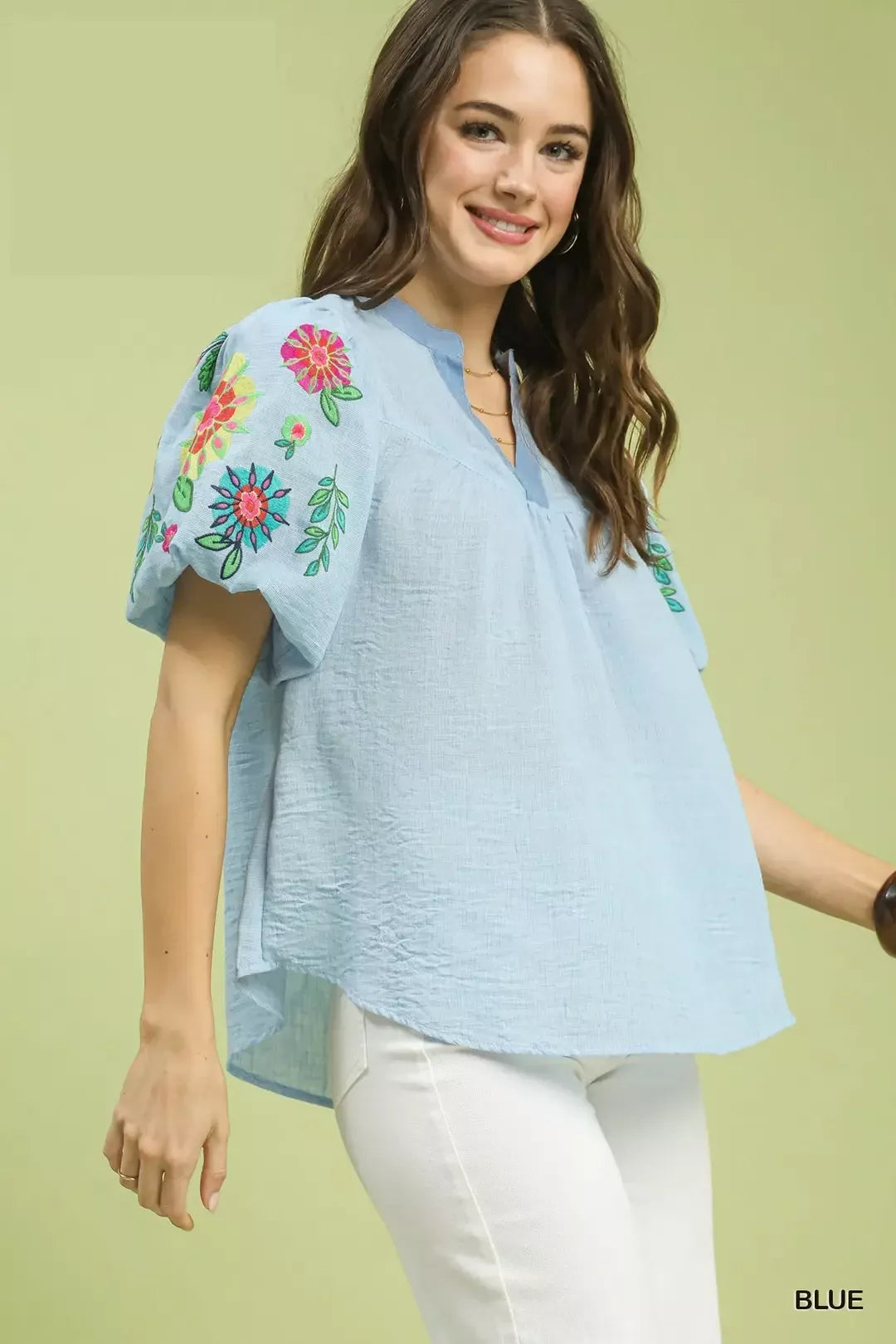 light blue embroidered peasant blouse with colorful floral puff sleeves and relaxed boho fit