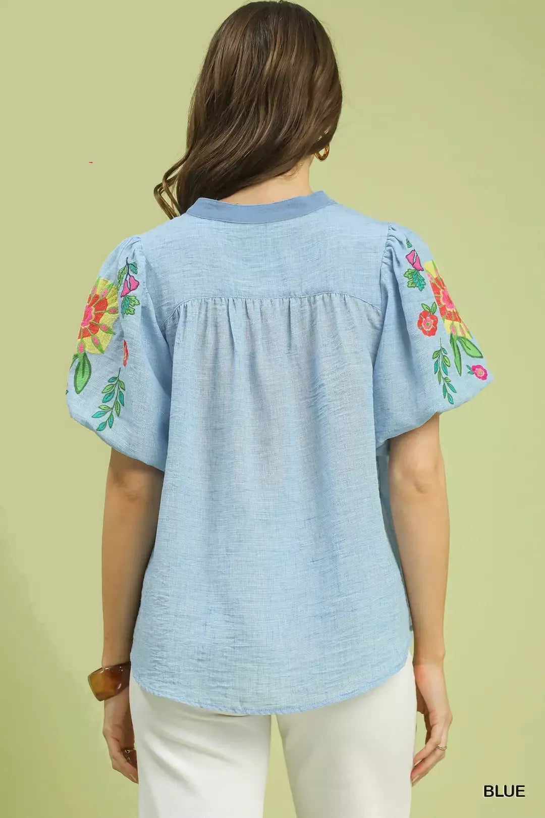 light blue embroidered peasant blouse with colorful floral puff sleeves and relaxed boho fit