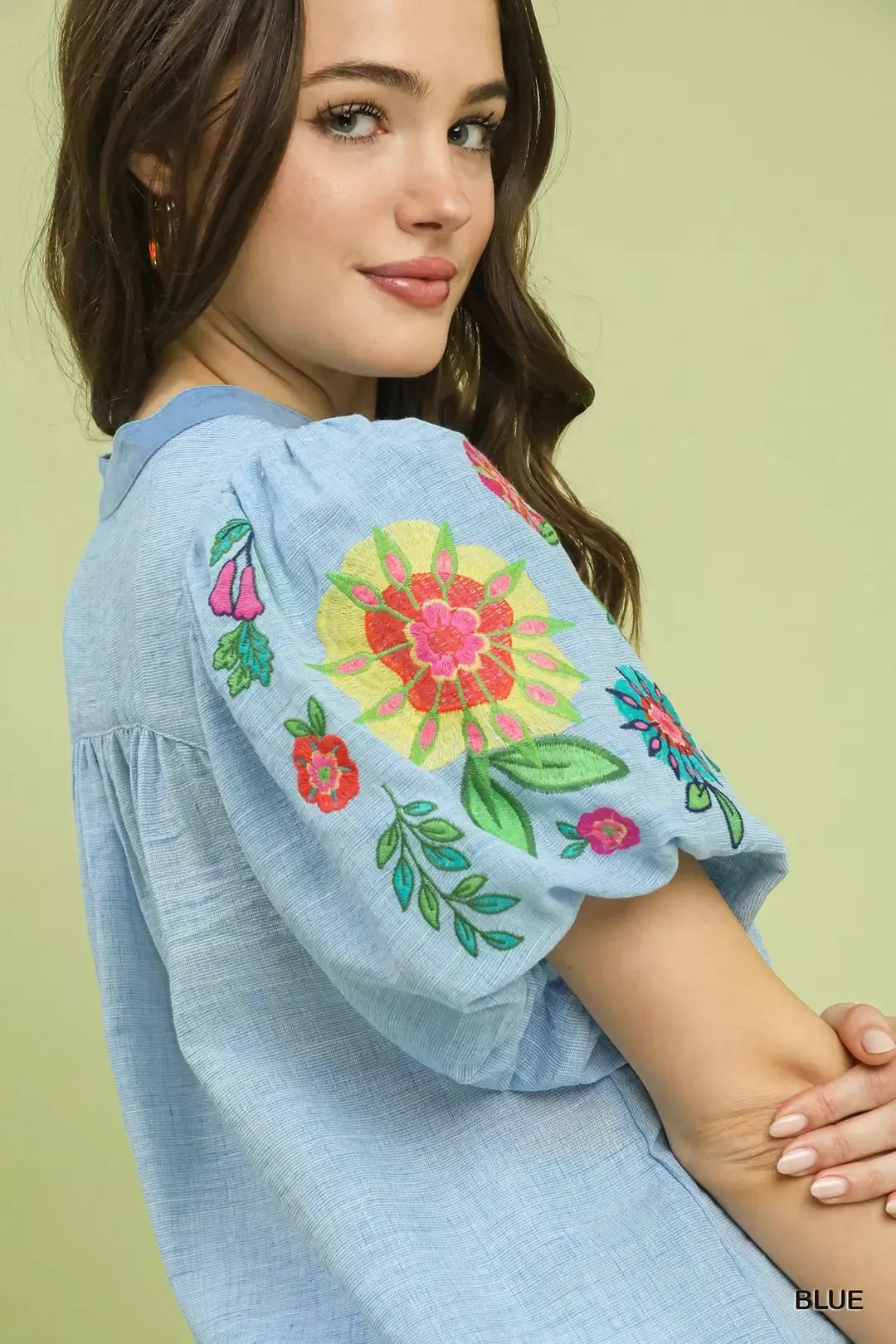 light blue embroidered peasant blouse with colorful floral puff sleeves and relaxed boho fit