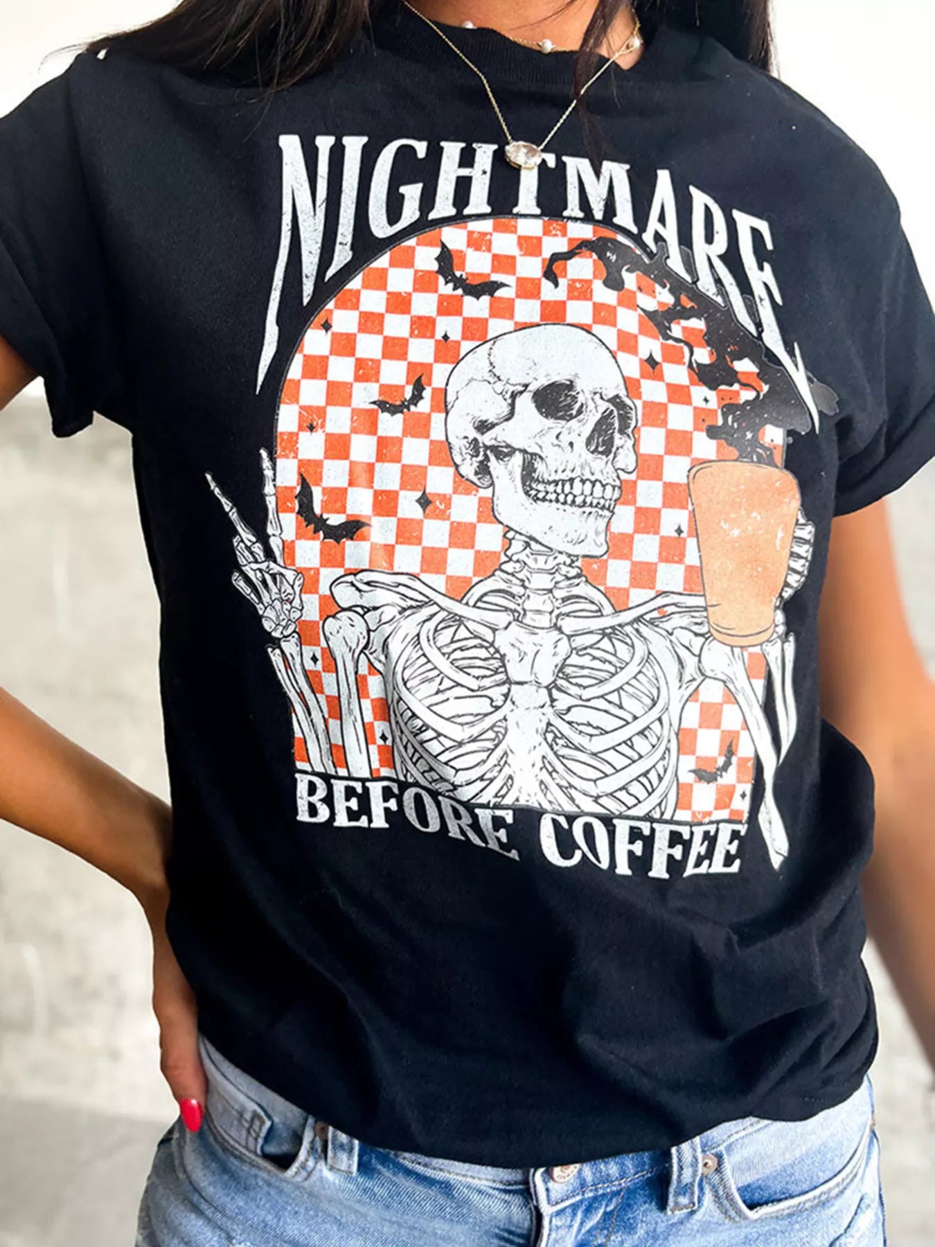 Black Halloween tee with skeleton holding coffee and “Nightmare Before Coffee” text – Nightmare style from A Whimsical Affair.