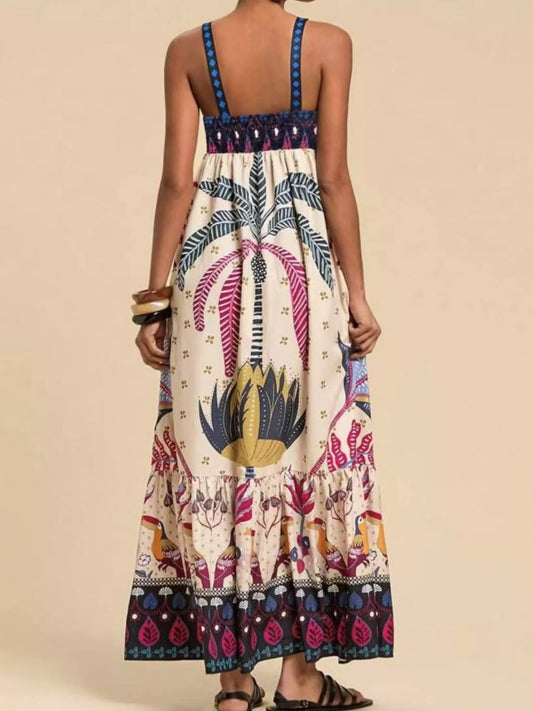 Boho strappy maxi dress with a bold mixed floral-inspired print, flowy skirt, and relaxed summer fit.