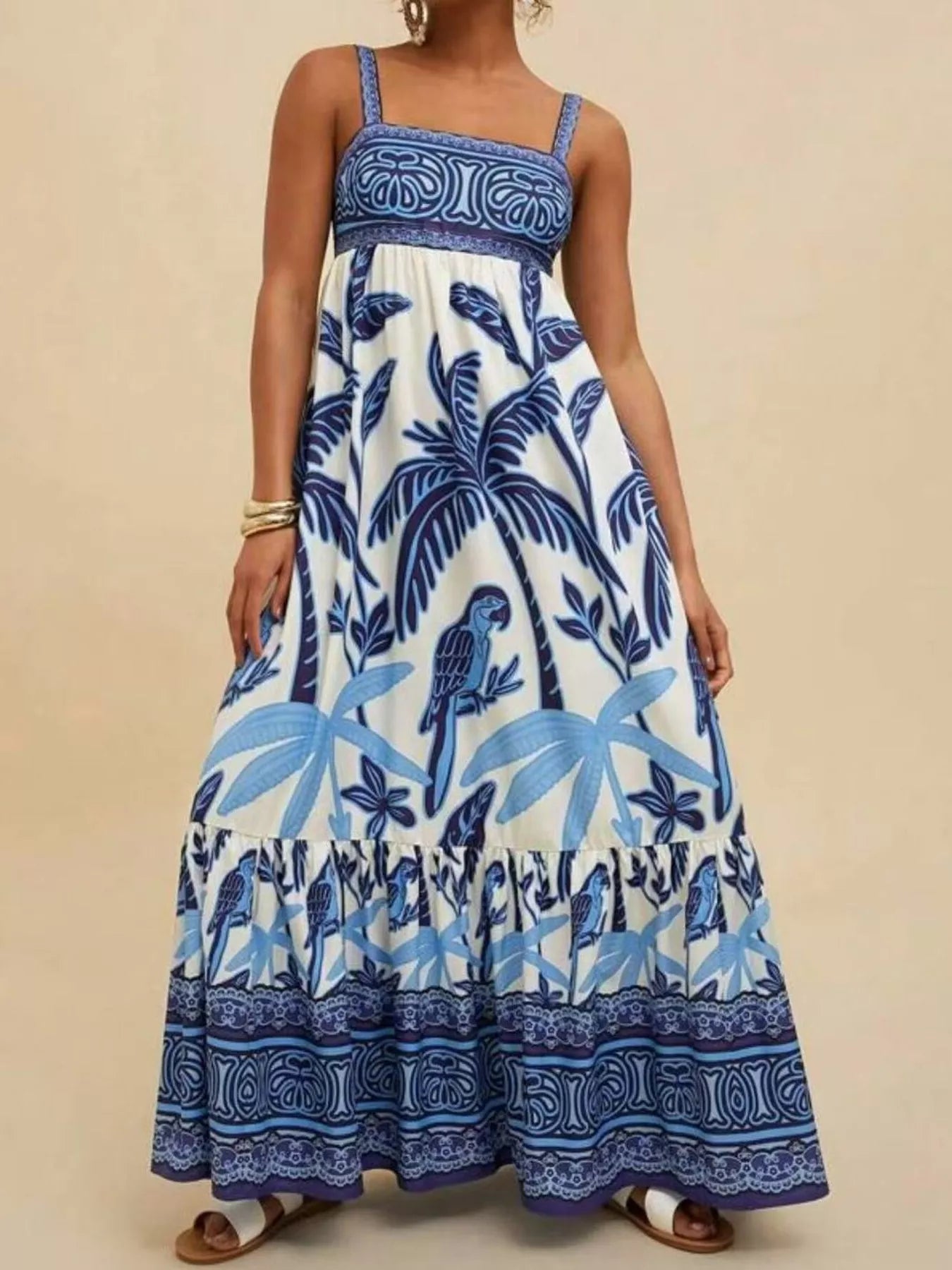 Boho strappy maxi dress with a bold mixed floral-inspired print, flowy skirt, and relaxed summer fit.