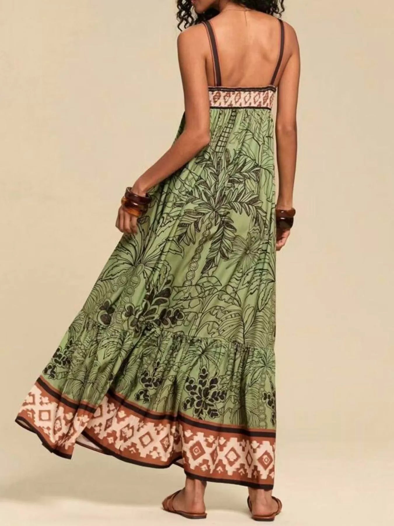 Boho strappy maxi dress with a bold mixed floral-inspired print, flowy skirt, and relaxed summer fit.