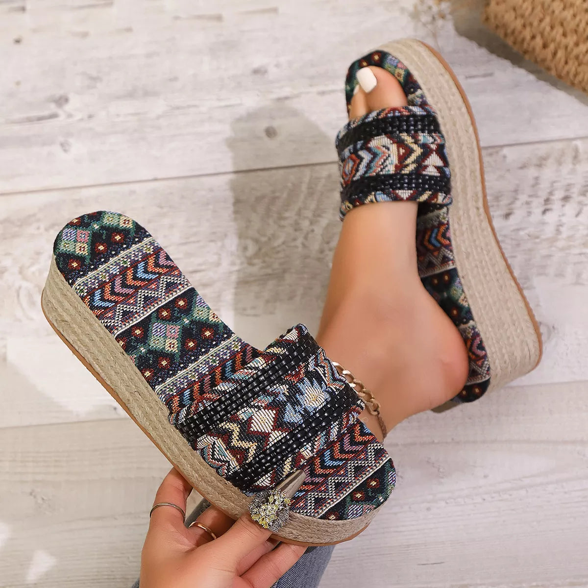 Boho slip-on platform sandals with patterned fabric straps, braided mid-heel sole, and rubber bottom styled with cropped denim.