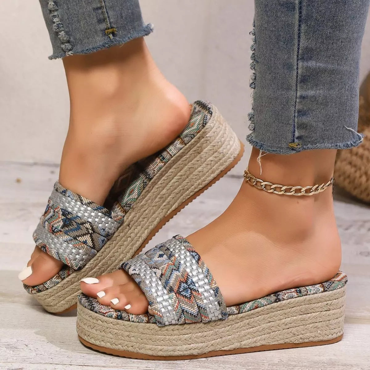 Boho slip-on platform sandals with patterned fabric straps, braided mid-heel sole, and rubber bottom styled with cropped denim.