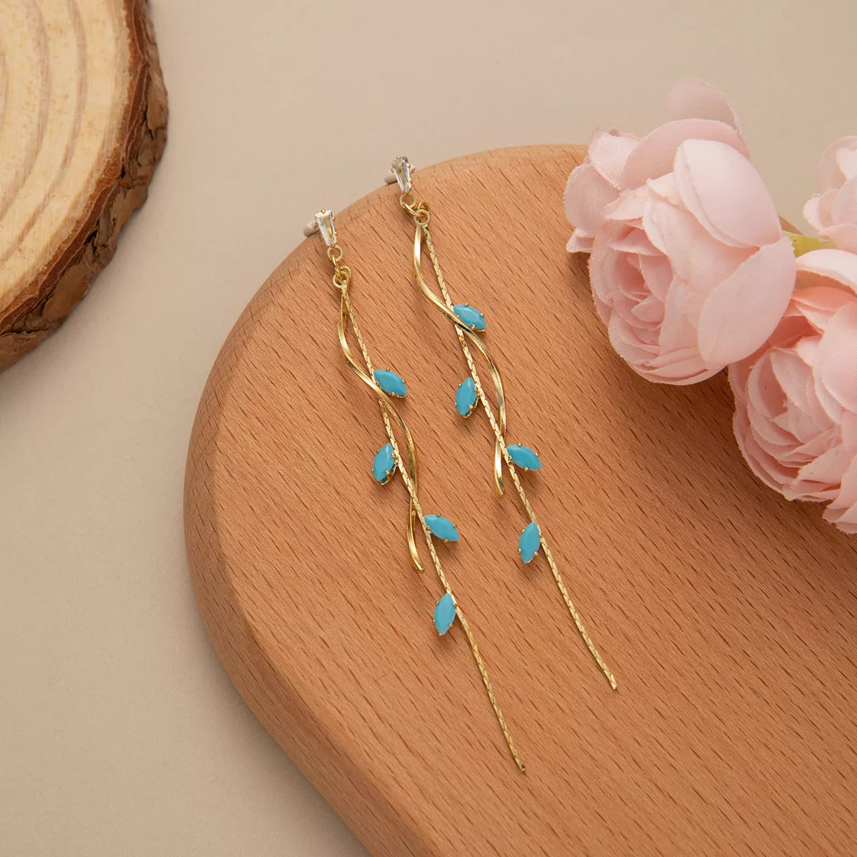 Woman wearing 18K gold-plated turquoise drop earrings with vine design — elegant ocean-inspired jewelry from A Whimsical Affair.