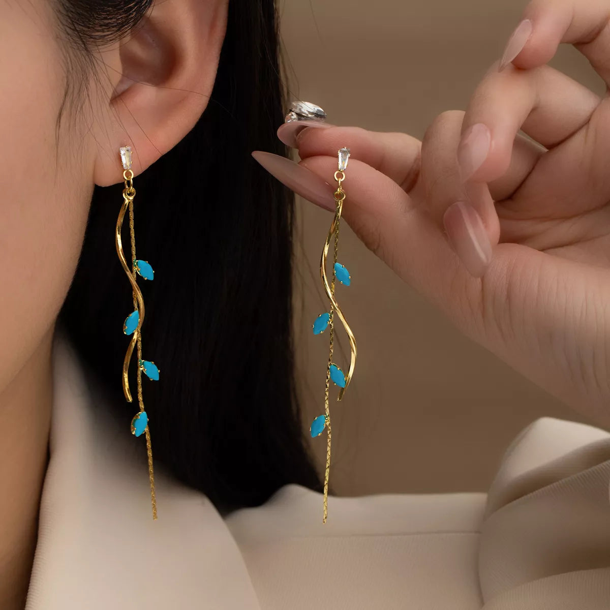 Woman wearing 18K gold-plated turquoise drop earrings with vine design — elegant ocean-inspired jewelry from A Whimsical Affair.