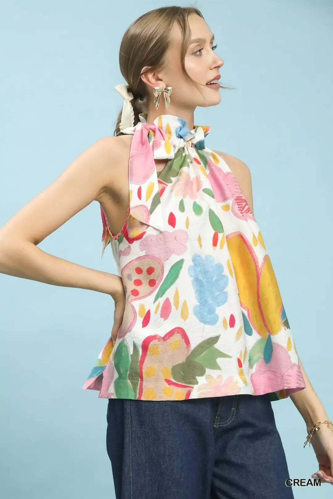 Multi-color floral halter neck boho top with ruffle detail, lace trim, and relaxed flowy fit styled with dark denim.