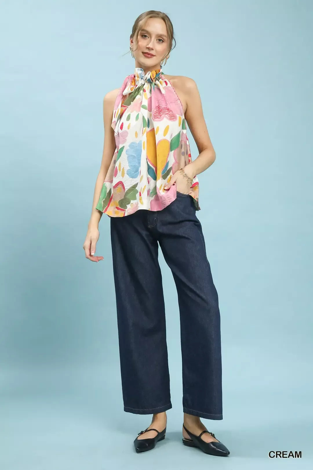 Multi-color floral halter neck boho top with ruffle detail, lace trim, and relaxed flowy fit styled with dark denim.