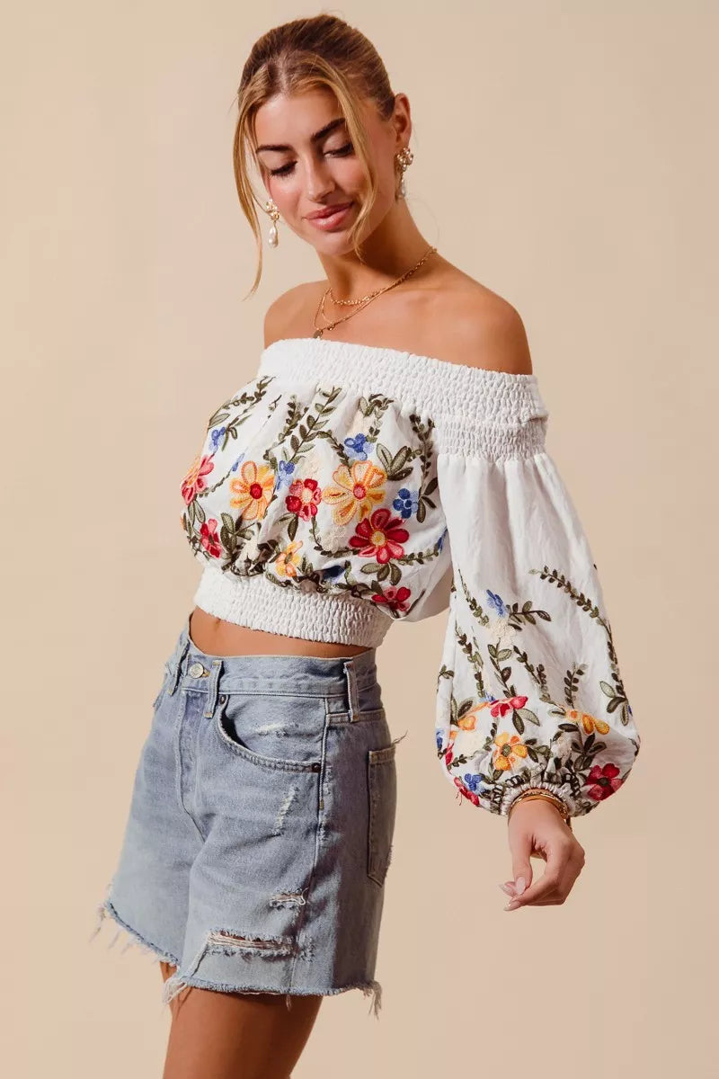 Floral embroidered off-the-shoulder crop top with a relaxed bohemian fit