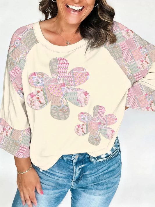 Cream pullover with patchwork floral appliqué and patterned sleeves