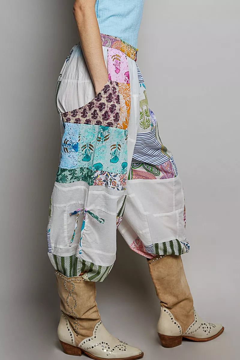 Wide-leg white patchwork cotton pants with colorful mixed print panels and pockets