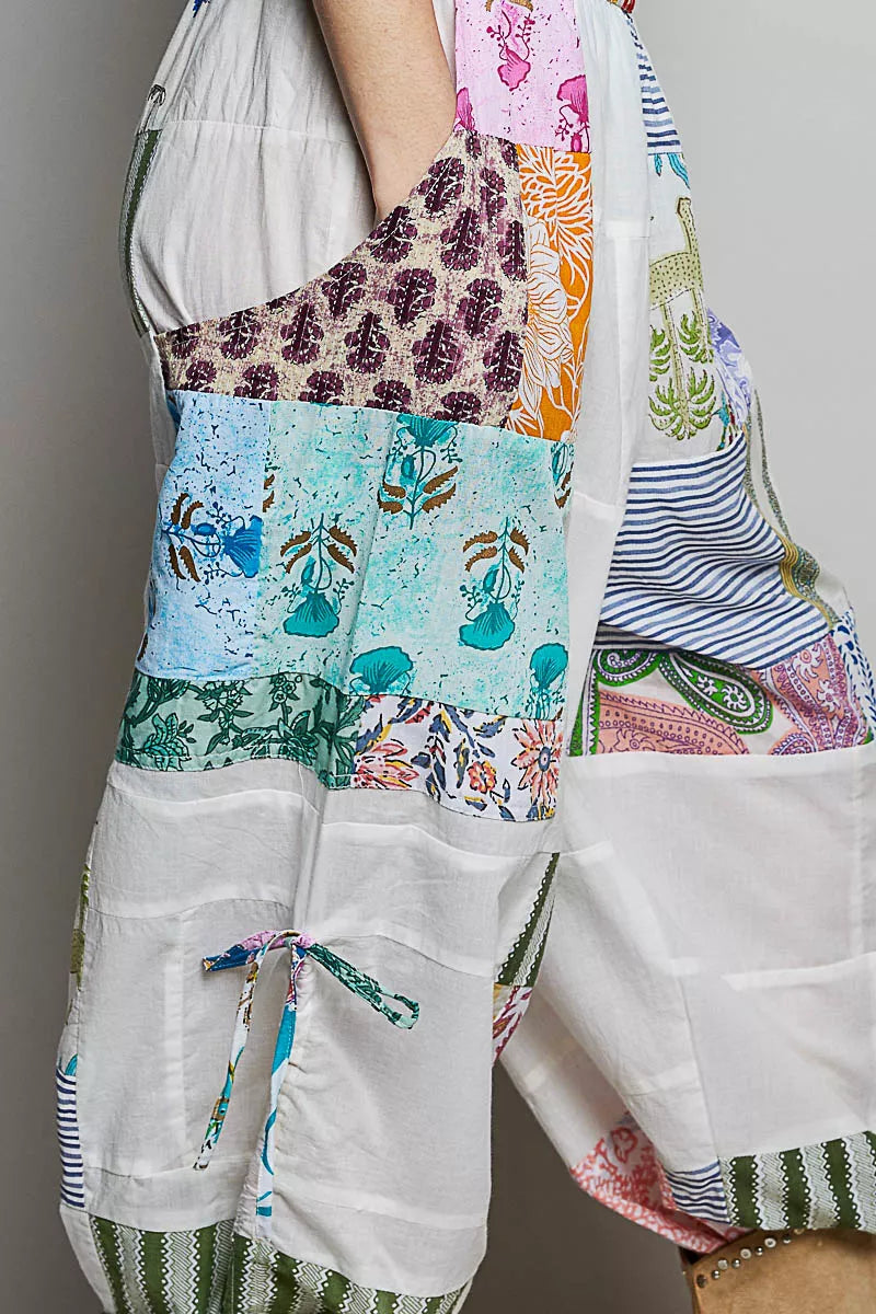 Wide-leg white patchwork cotton pants with colorful mixed print panels and pockets