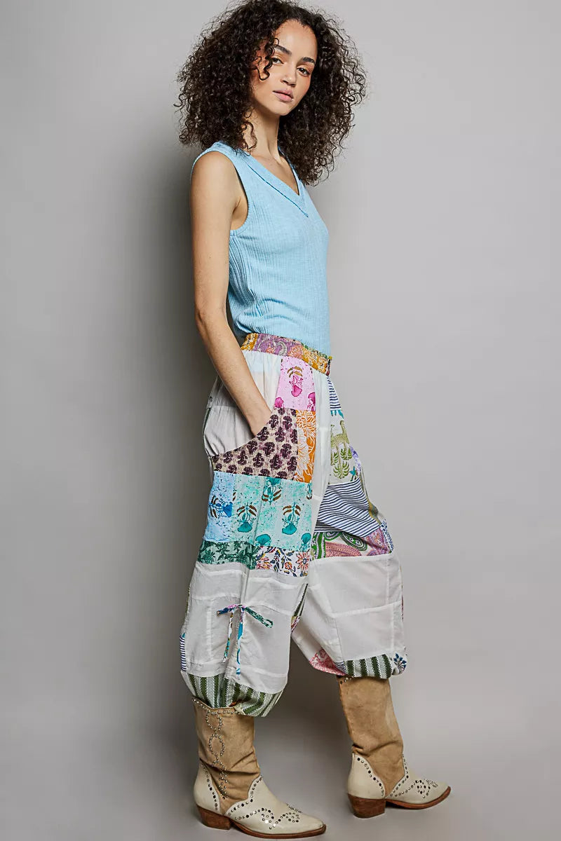 Wide-leg white patchwork cotton pants with colorful mixed print panels and pockets