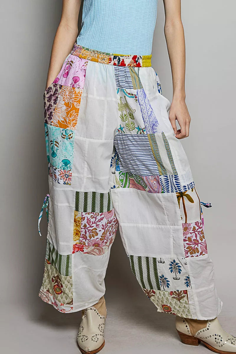 Wide-leg white patchwork cotton pants with colorful mixed print panels and pockets