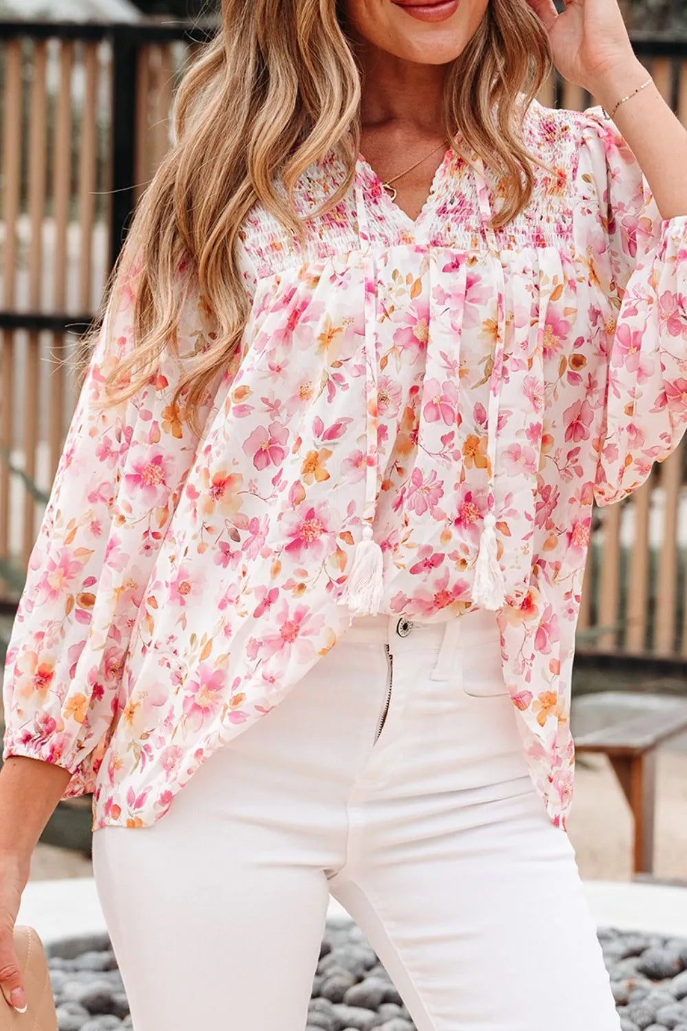 Pink floral smocked blouse with long sleeves and front tie detail