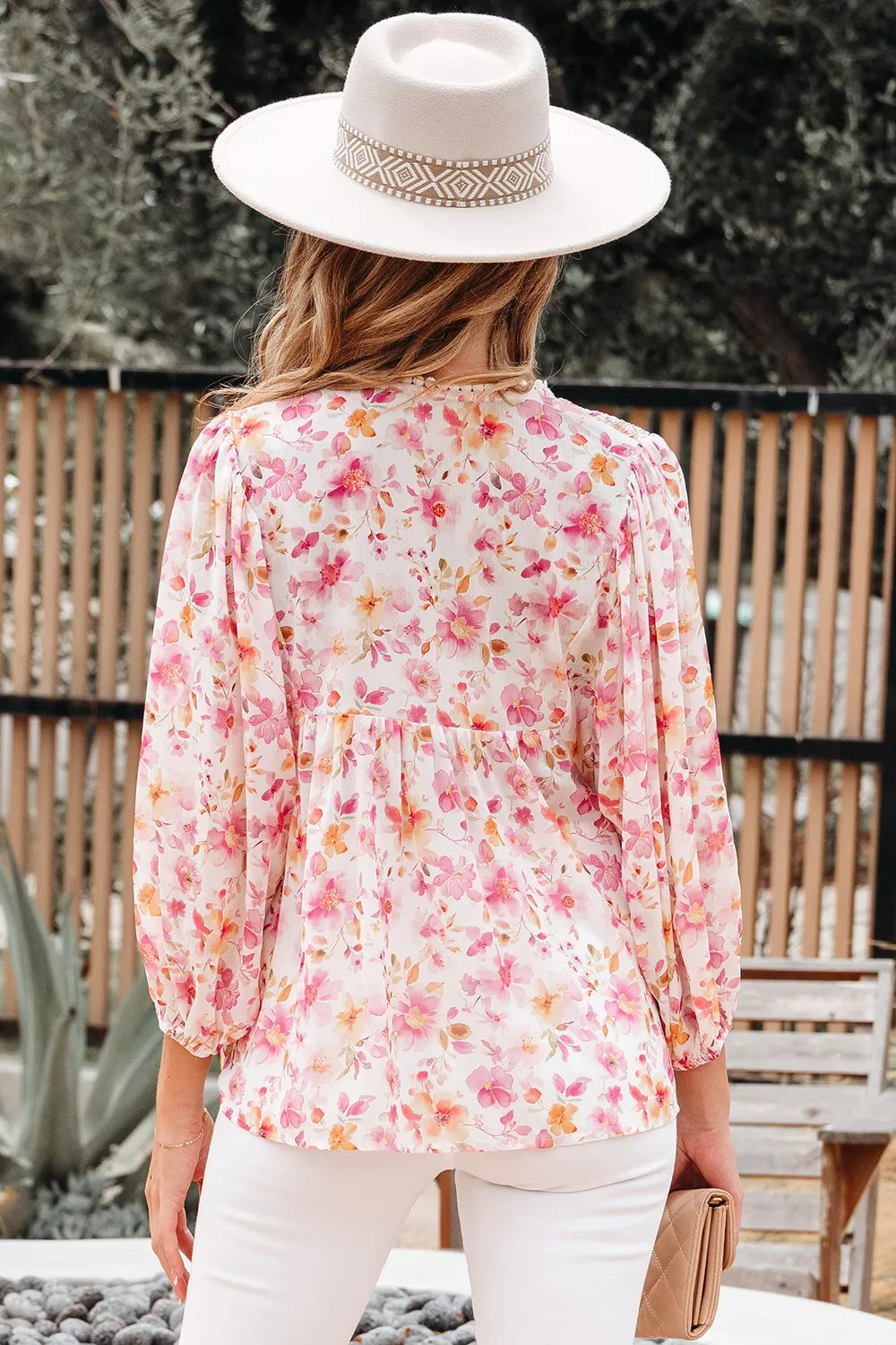 Pink floral smocked blouse with long sleeves and front tie detail