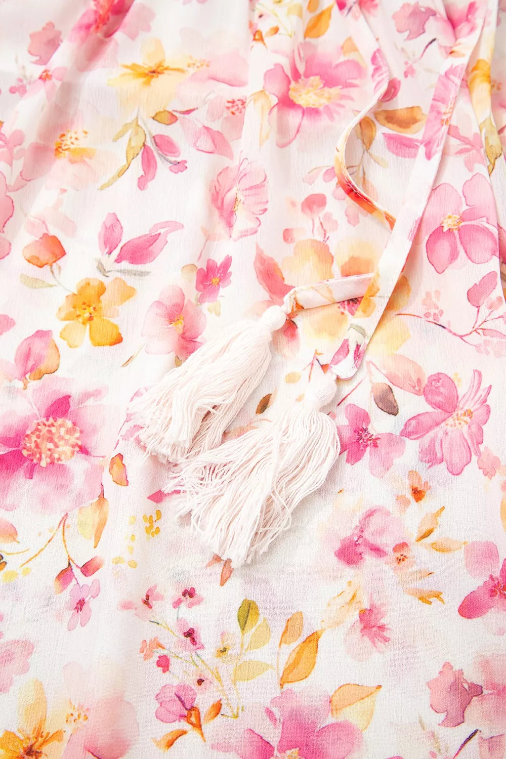 Pink floral smocked blouse with long sleeves and front tie detail