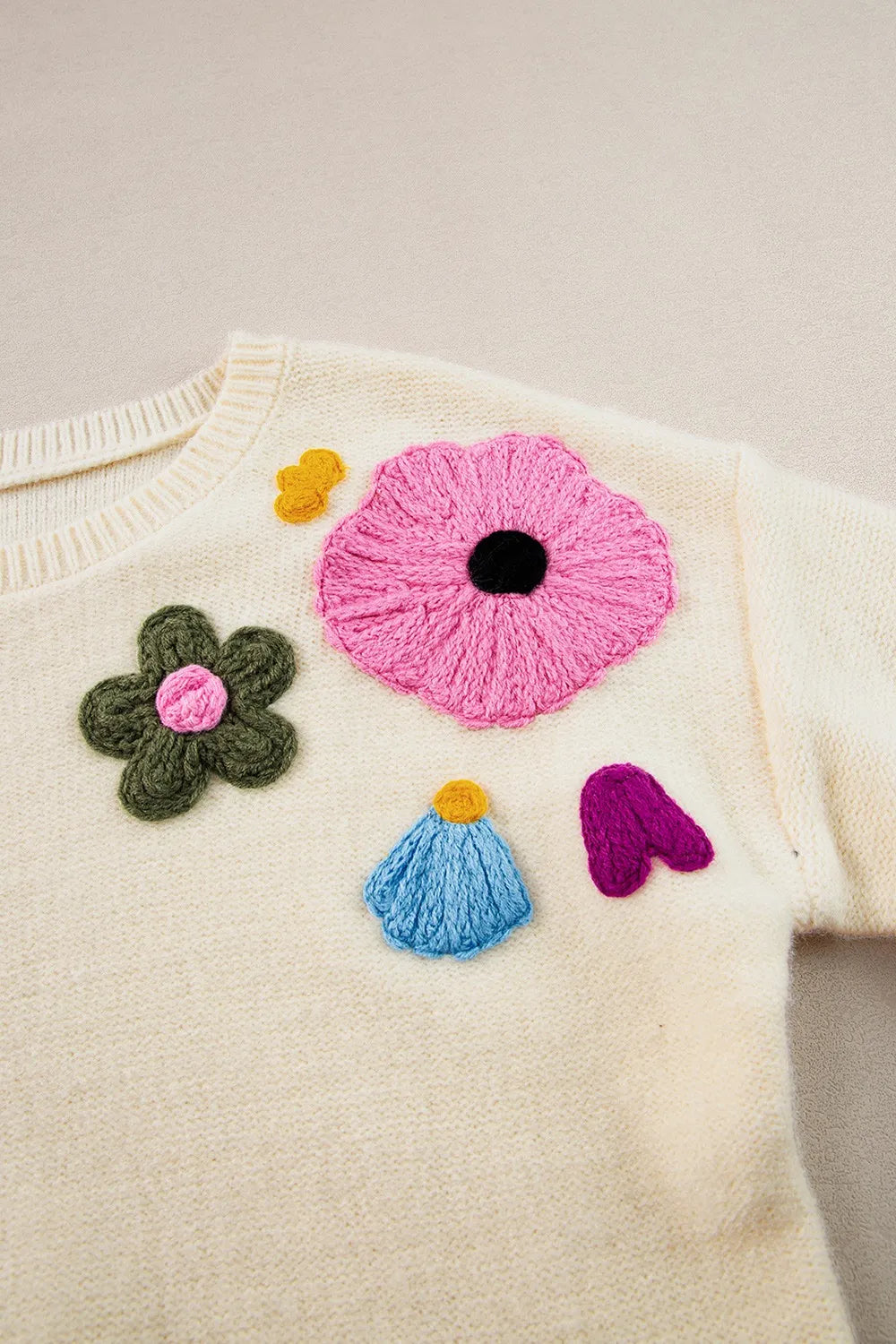 Whimsical boutique floral appliqué knit sweater with relaxed fit