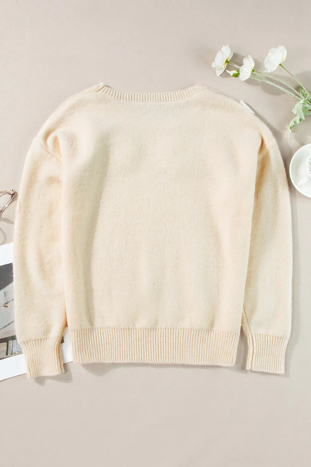 Whimsical boutique floral appliqué knit sweater with relaxed fit