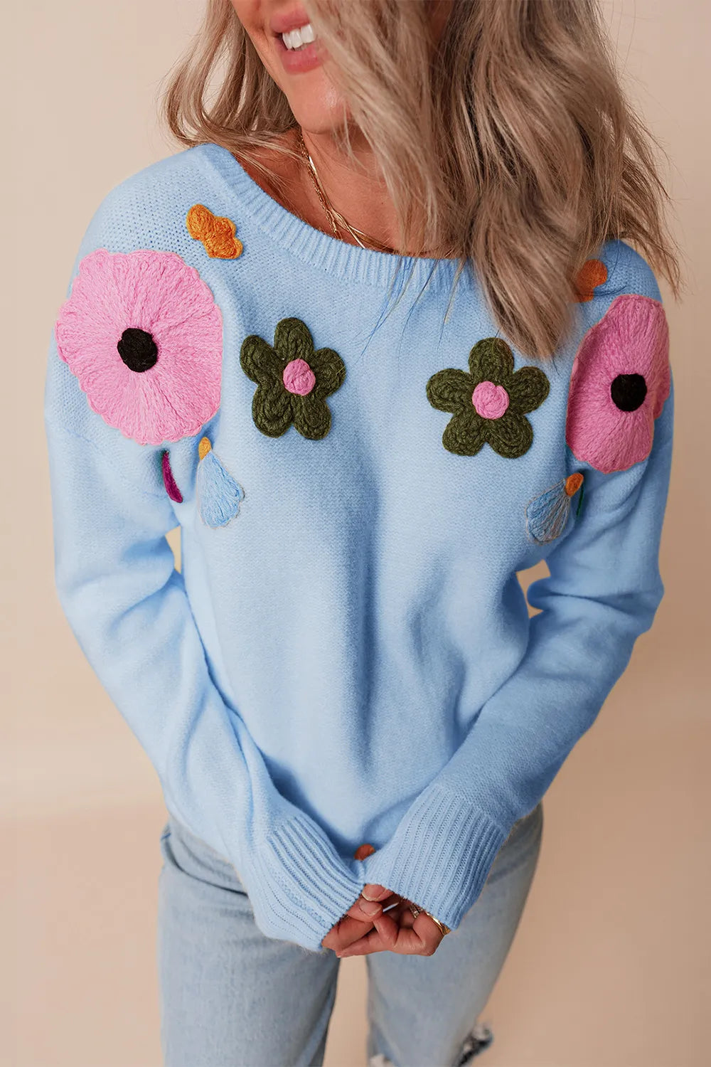 Whimsical boutique floral appliqué knit sweater with relaxed fit