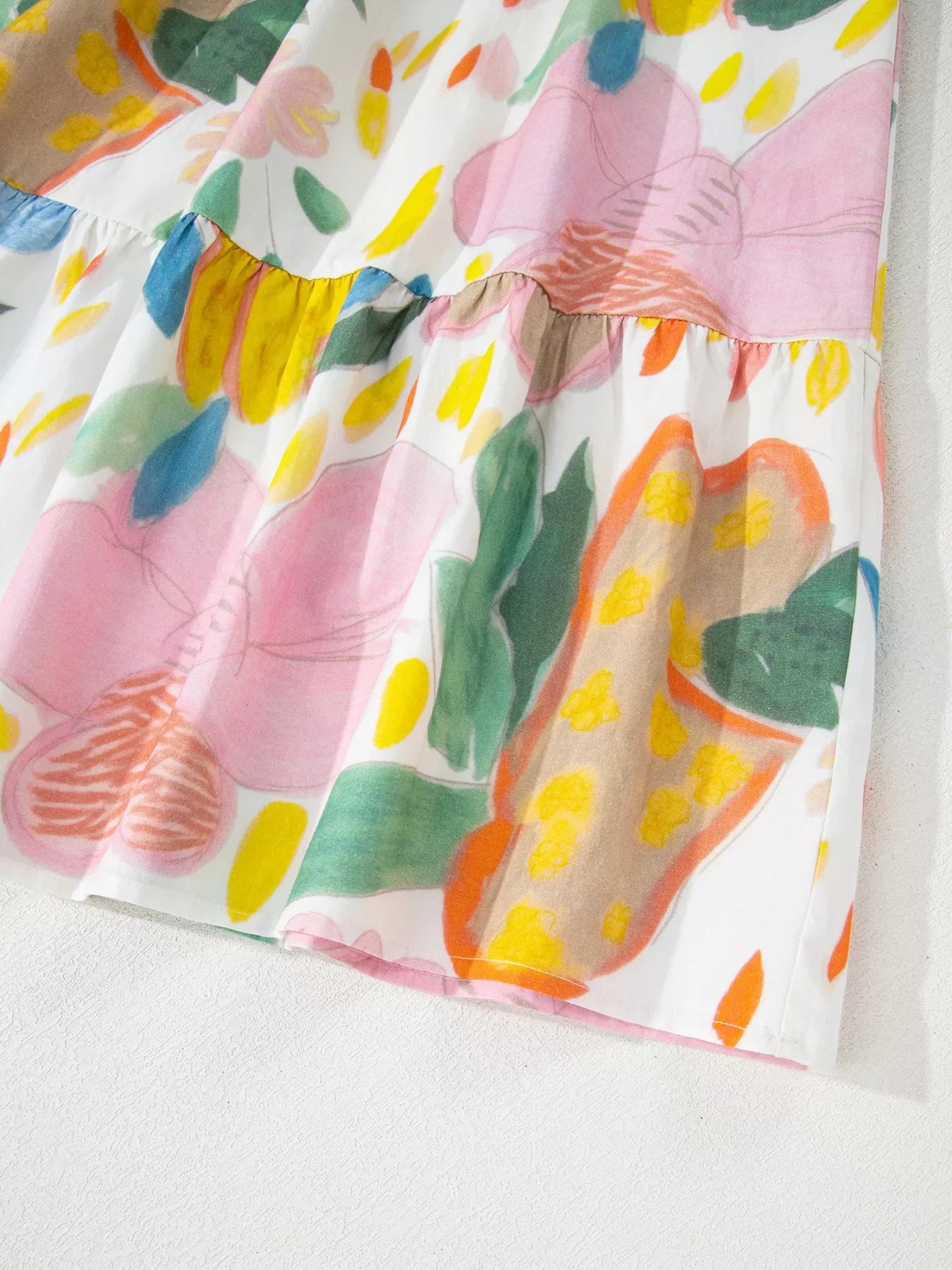 Colorful abstract floral tiered midi dress with flowy silhouette