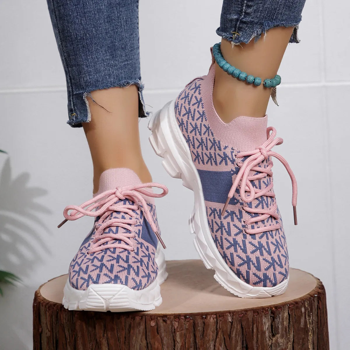 Pink and blue knit sneakers with chunky sole, styled with cuffed jeans for a casual whimsical look
