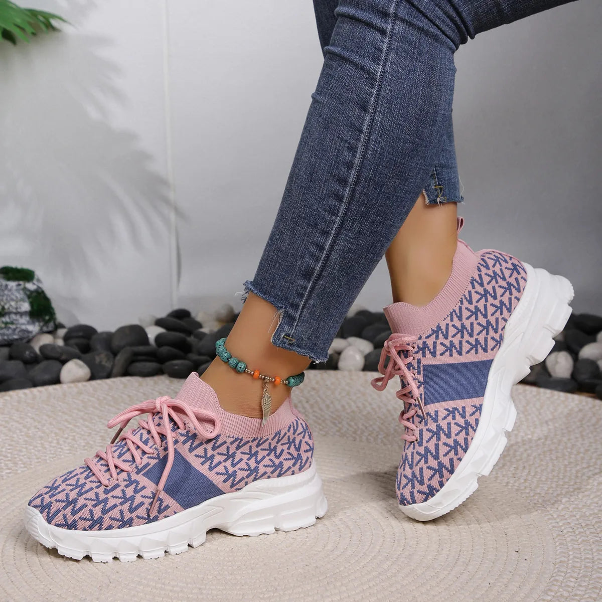 Pink and blue knit sneakers with chunky sole, styled with cuffed jeans for a casual whimsical look