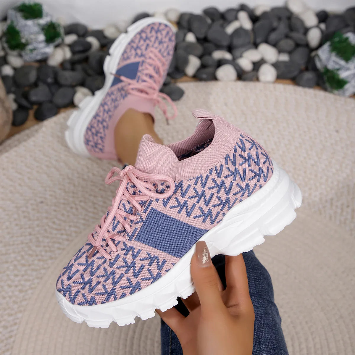 Pink and blue knit sneakers with chunky sole, styled with cuffed jeans for a casual whimsical look