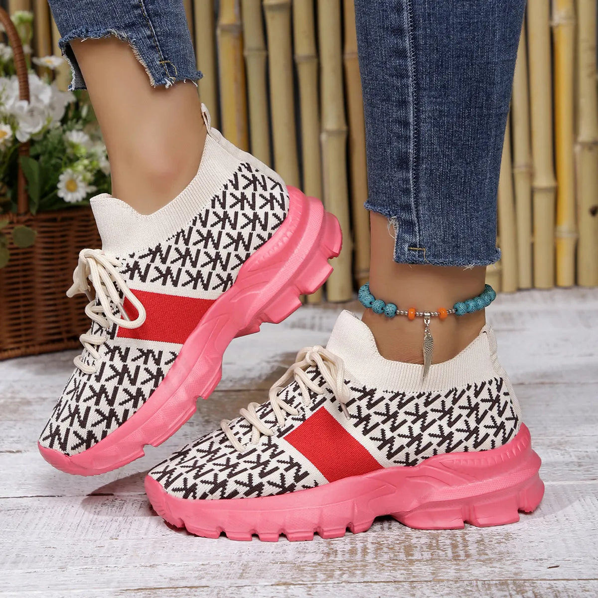 Pink and white knit sneakers with chunky sole, styled with cuffed jeans for a casual whimsical look