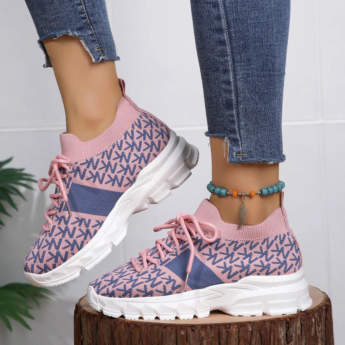 Pink and blue knit sneakers with chunky sole, styled with cuffed jeans for a casual whimsical look