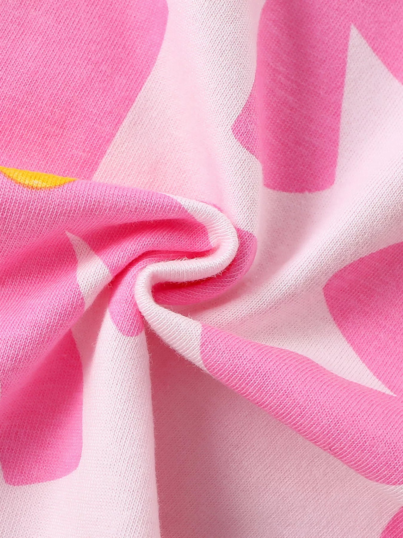 Girls pink short sleeve tee with oversized flower print, relaxed fit, and soft cotton-blend fabric styled with denim shorts.
